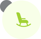 A green rocking chair sitting in front of a white wall.